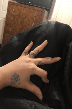 Live laugh love and an Anchor on fingers and a small ganesha on hand 