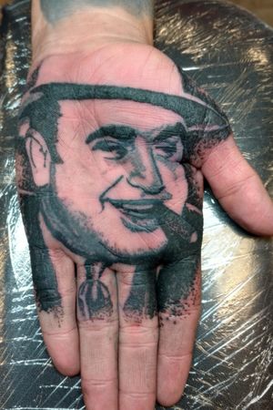 Dot portrait of Al Capone on a palm