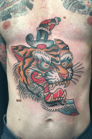 Big and bold tattoo of a tiger and dagger in the traditional american style by Carl Hallowell for Mr A... #CarlHallowell #traditional #traditionaltattoo #traditionalamerican #TraditionalArtist #dallastattooartist #Texas #oldschool #oldschooltattoo #tiger #dagger #fullcolor #fullfronttattoo #stomachtattoo 