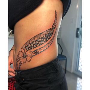 Ladies hip side and rib mixed tribal tattoo 