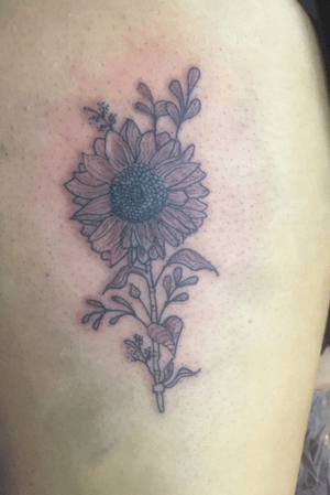 A sunflower doneon the side of the thigh 