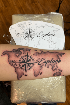 World map with compass tattoo