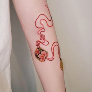 Red norigae of hibiscus inside a frame flowing down the arm, done in Hong Kong.#tattoo #Korea #tattooart #koreatattoo #koreatattooist #flowertattoo #illustration #birthflowertattoo #tattooistartmag #hongdae #flowers #coloredtattoo  #watercolortattoo #hongdaetattoo #norigae #tattooistsion 