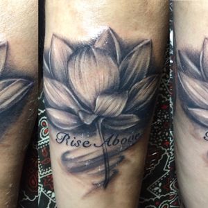 Black and Grey lotus flower on the back of forearm 