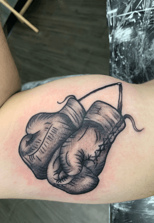Hanging boxing gloves on right bicep! Done by man rish at boss frogs in mckinney! 