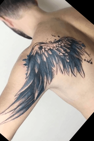 Black and grey wing tattoo on the right upper arm and