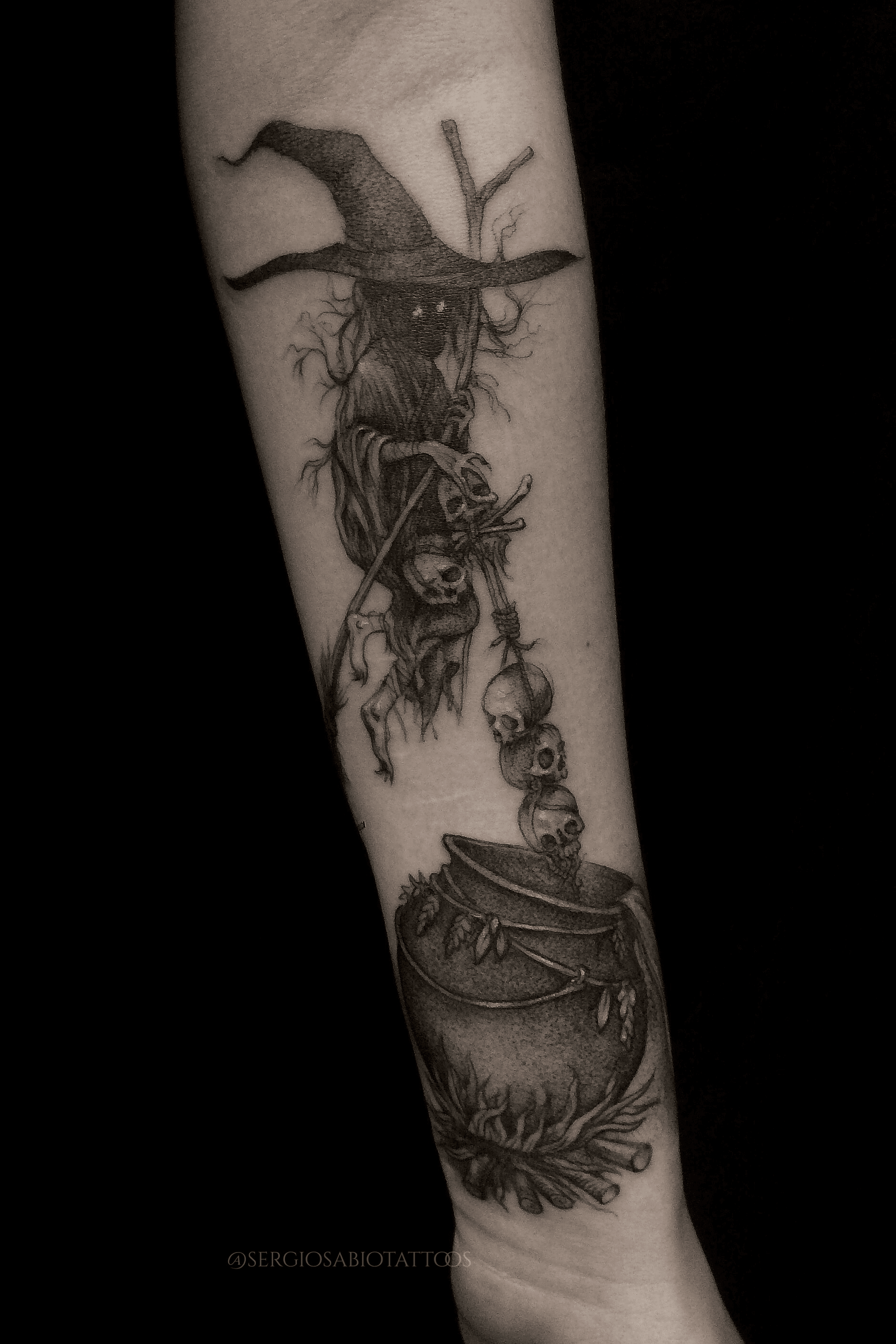 Sketch work witch portrait tattoo on the upper arm