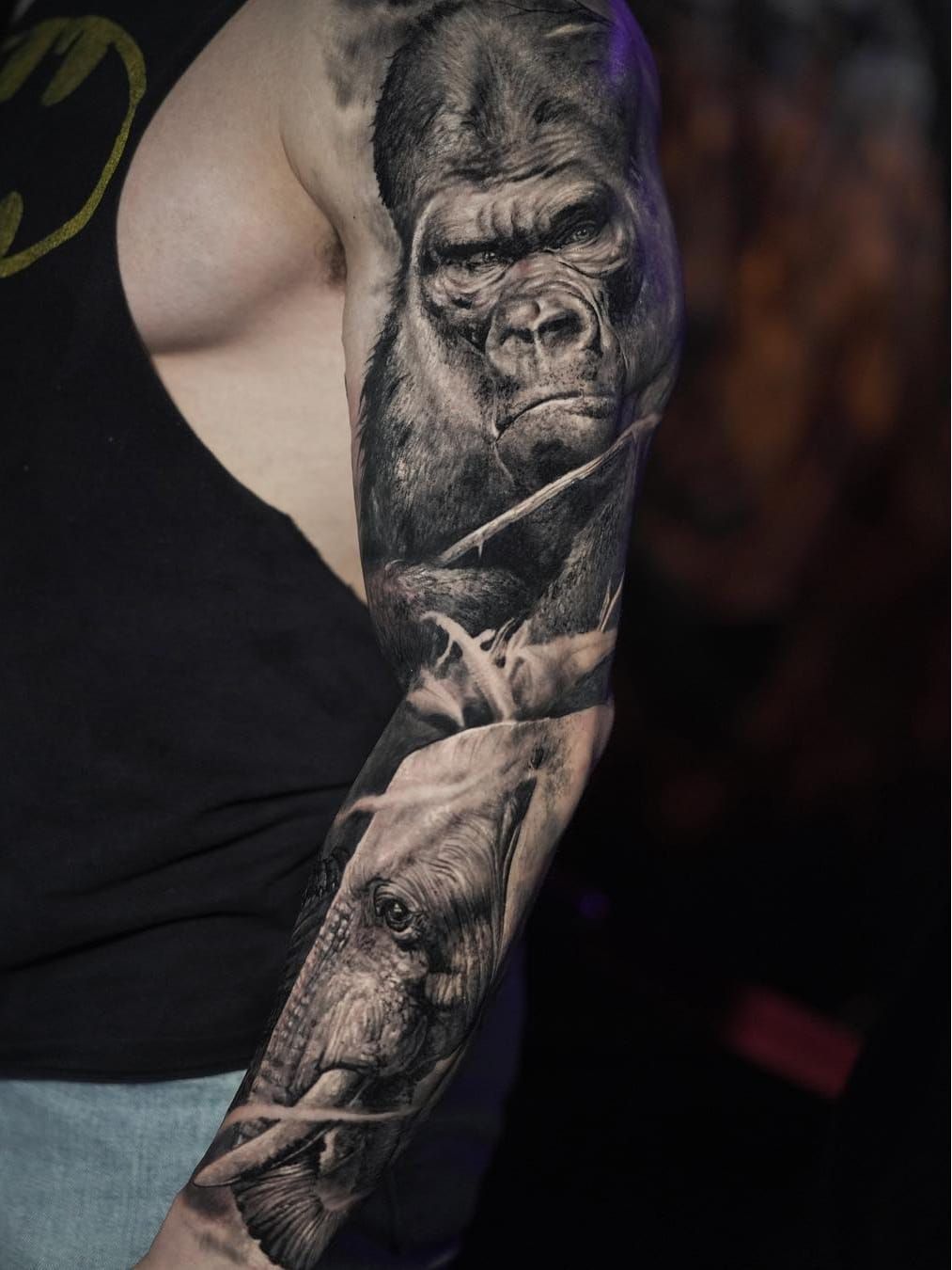 Minimalistic monkey portrait tattoo done on the upper