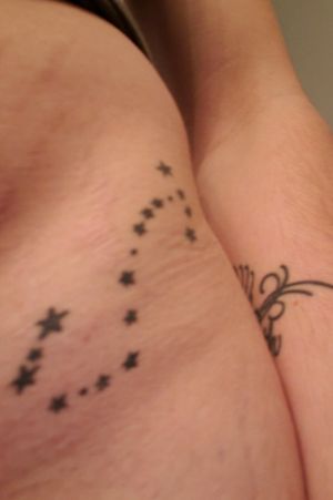 Astrological star sign on front left hip