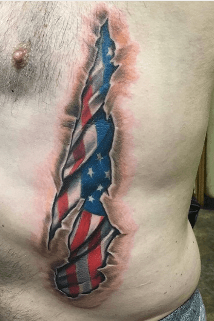 Black Ink Ripped Skin American Flag Tattoo On Man Right Front Shoulder