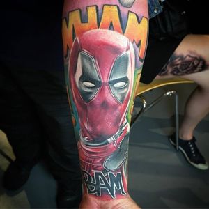 Deadpool colour realism tattoo on forearm, with onomatopoeia embelishment. 