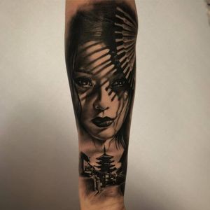 Black and white realism tattoo of geisha on forearm.