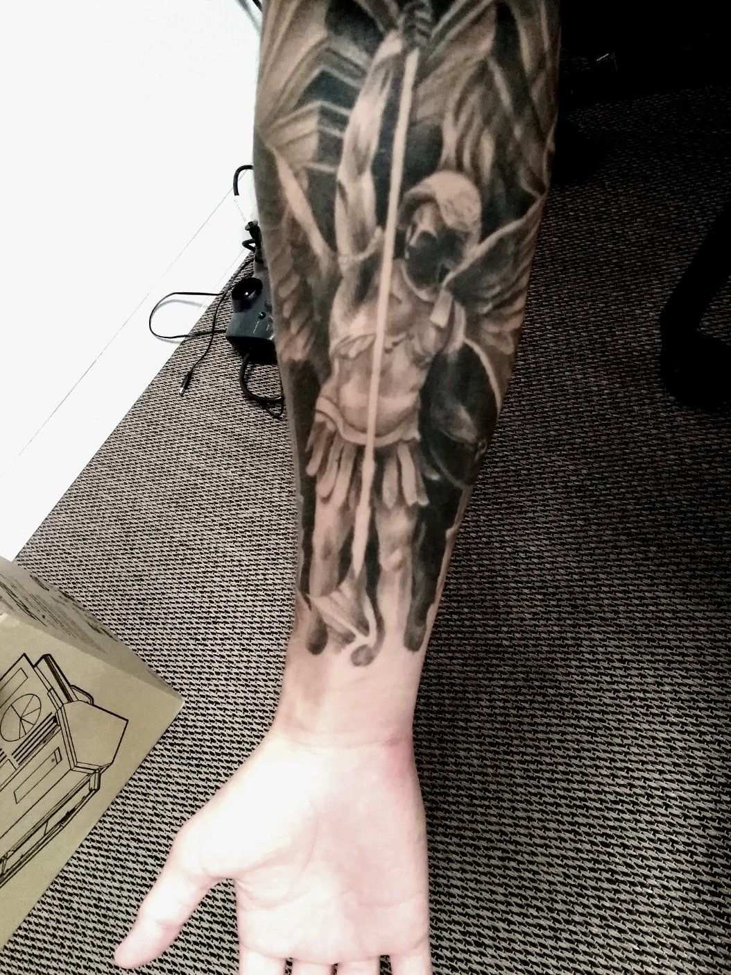 Black Outline Archangel Michael Tattoo On Left Forearm