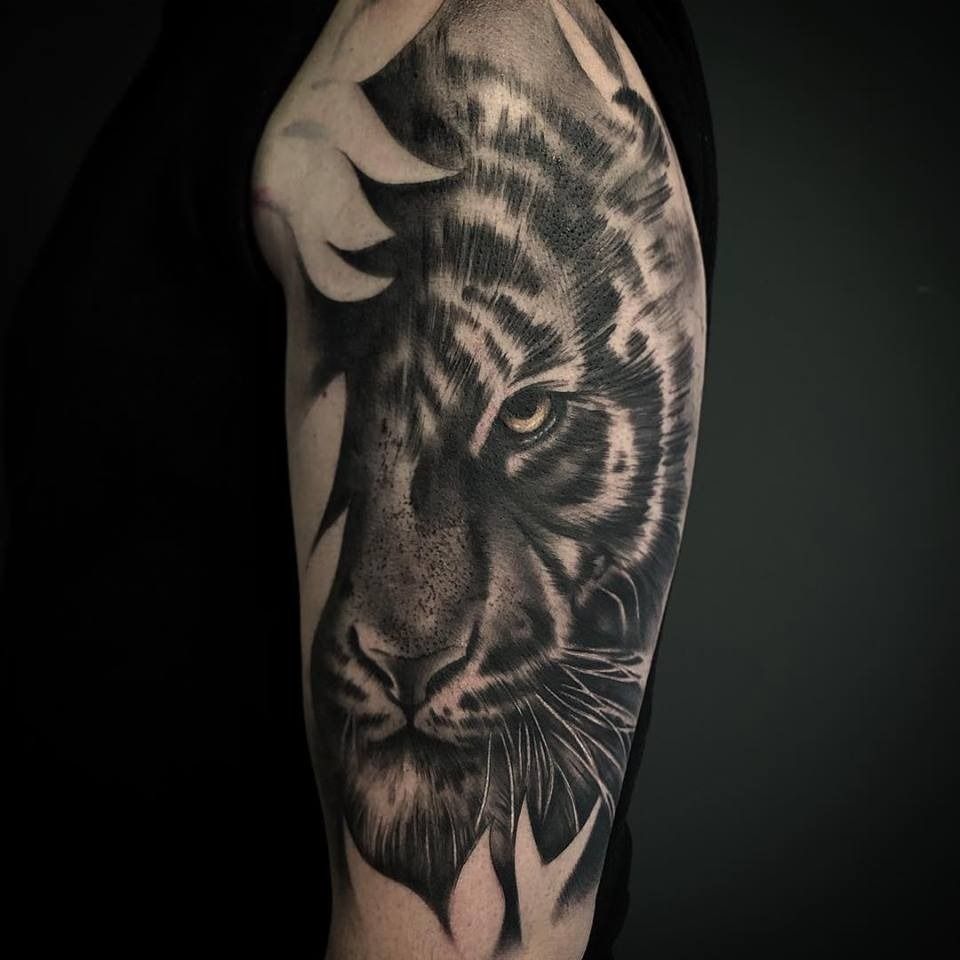 Tattoo uploaded by Curro López • Black and white realism tattoo on arm of  tiger hidden in the blossoms. • Tattoodo