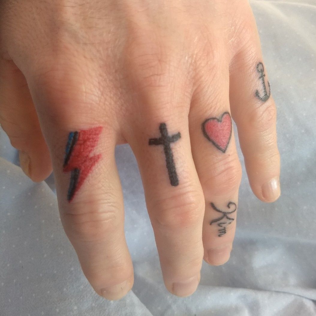 cross on finger tattoo