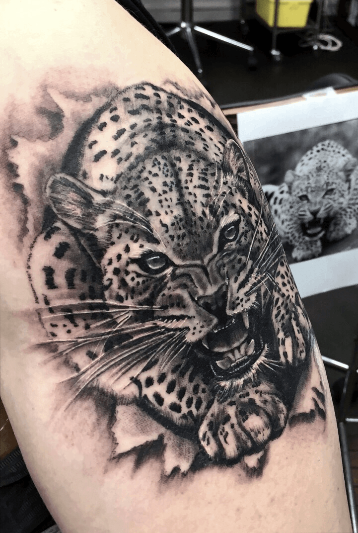 Microrealistic style leopard tattoo located on the
