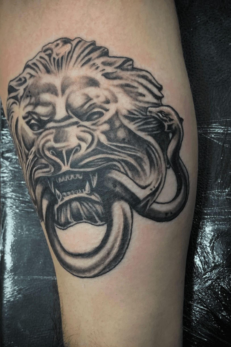 Tattoo uploaded by Christian  Side view of lion statue biting snake   Tattoodo