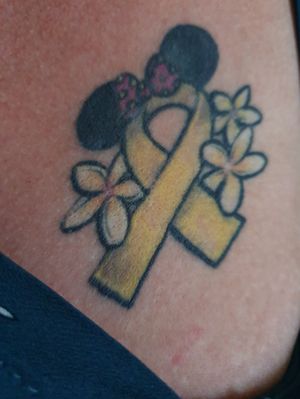 This tattoo was to represent my young daughters fight with childhood cancer (a fight that she bravely won). It's the gold ribbon for childhood cancer, Minnie mouse ears (Minnie mouse was her favourite during treatment and her Minnie mouse teddy comforted her a lot during her lengthy stays in hospital) and as her type of cancer was called neuroblastoma (which in Australia is represented by a frangipanni) I got the frangipannis around the ribbon. 