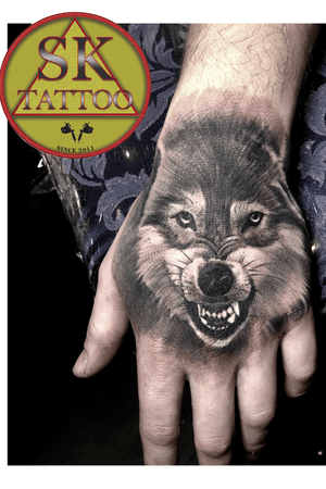 Wolf hand tattoo