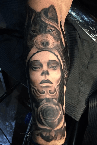 Black and grey indian and wolf with a rose, on forearm
