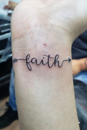 Faith small lettering tattoo done by artist Elias Mora at Arte Tattoo Studios located in Gainesville Georgia! 