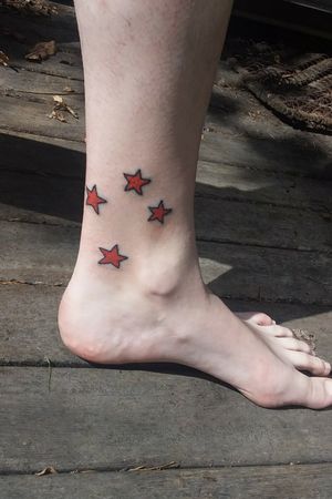 lower leg tattoo of new zealands flag southern cross stars