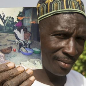 Nega, a Imam for his tribe, showing a photo of his daughter who died due to FGM.