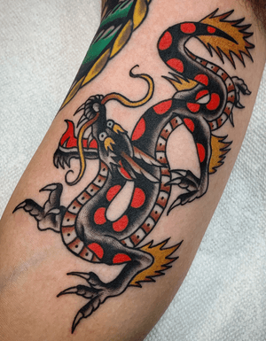 Tattoo by @zimovan. #dragon #traditionaltattoo #classictattoos #bright #BoldTattoos #oldschool #flames #dragontattoo #AmericanTraditional #color #ashevillenc #ashevilletattoos #nctattooers 