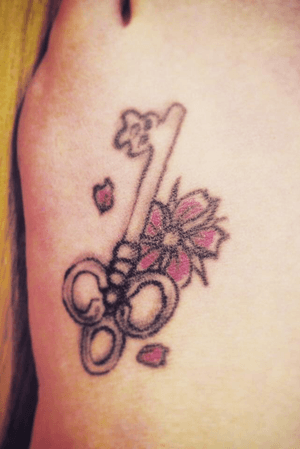 A skeleton key with pink blossom done by TattooStu (Stuart Rowles) on Friday the 13th. I have since gotten a lot more Friday the 13th tattoos but this was my very first.