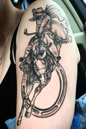 This was my first tattoo. I had a “go big or go home” mentality, so why not a tattoo of something that I love? A cowboy on a bucking bronco with a horseshoe. Perfect tattoo for a cowboy/cowgirl. 