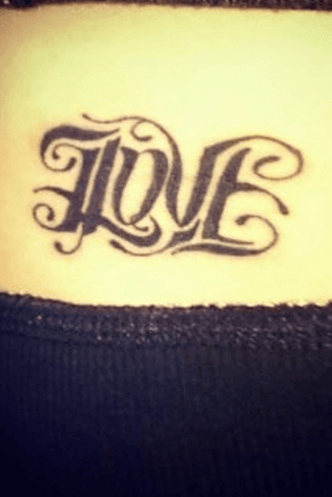 It says love at first glance; upside down it says hate. Done in Silverdale, Wa but i do not recall the shop/artist