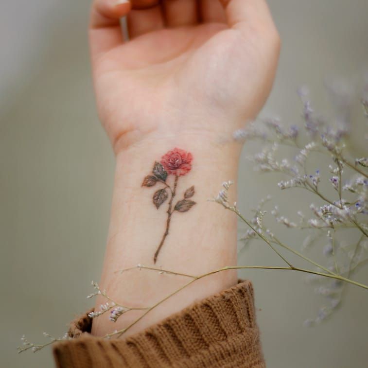 Tattoo uploaded by Justine Morrow • Rose tattoo by Donghwa #Donghwa  #selfharmscarcoveruptattoo #coveruptattoo #scarcoveruptattoo #scarcoverup # coverup #rose #flower #floral #delicate #minimal #small #leaves #thorns  #nature • Tattoodo