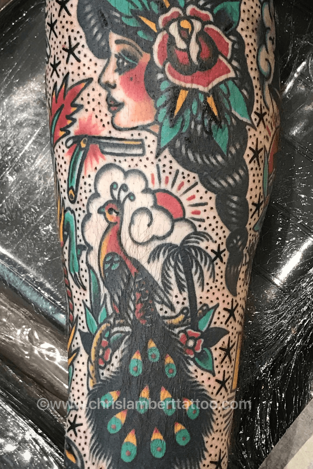 Traditional style peacock tattoo on the right calf