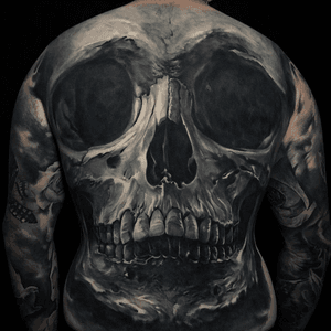 Epic black and grey realistic skull backpiece by Edgar.