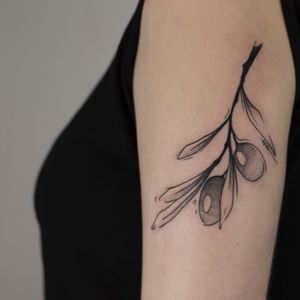 olive branch on girl arm 
