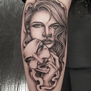 Intricate black and gray forearm tattoo of a beautiful woman wearing a striking mask by talented artist Dani Mawby.