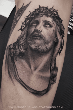 Get a striking black and gray Chicano-style Jesus tattoo on your upper arm. Book your appointment in London today!