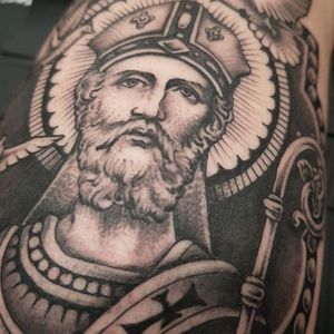 Unique blackwork tattoo of a man with a beard and cap on the arm, designed by Dani Mawby.