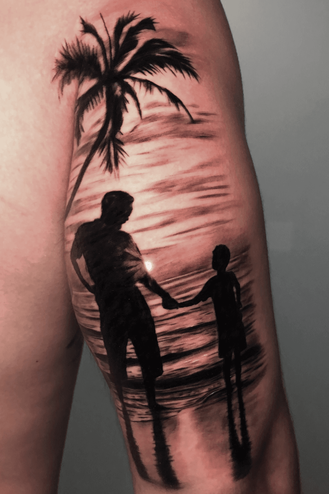 Minimalist sunset tattoo on the tricep