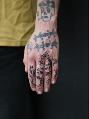 Non electric Hand poke tattoo by Blame Max #BlameMax #handpoke #stickandpoke #nonelectric #linework #illustrative #fineline #dragon #fire #handtattoo #fingertattoo