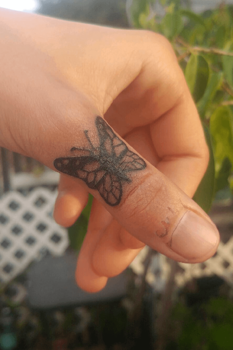 Thumb finger butterfly tattoo