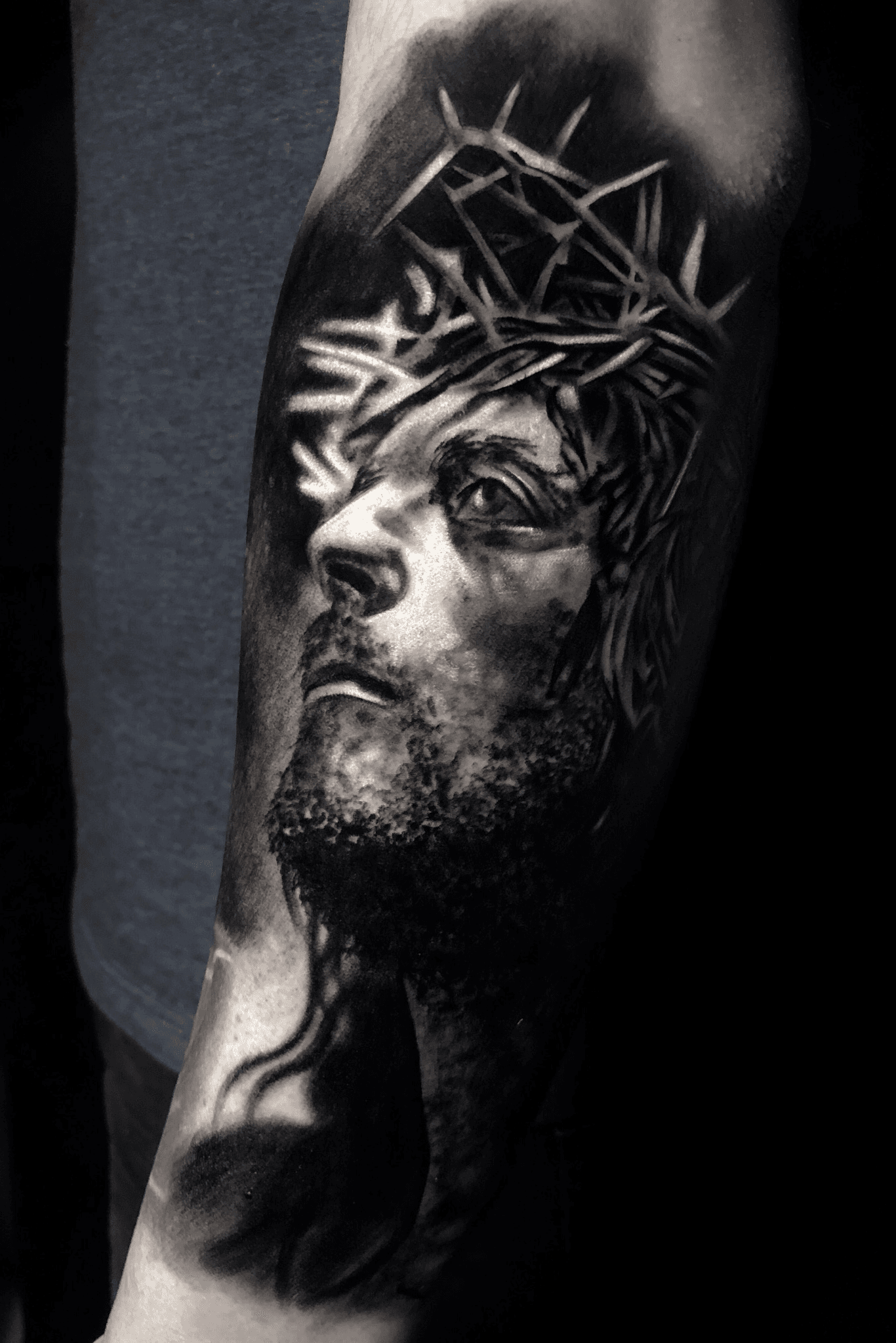 Black And Grey Jesus Face Tattoo Design For Arm By Craig Wright