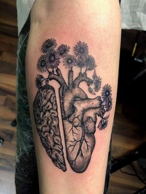 Tattoo by Alejandro Muñoz Leal. Anatomical heart with sunflowers.