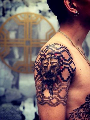 Tattoo by Alejandro Muñoz Leal. Mapuche iconography with mask.