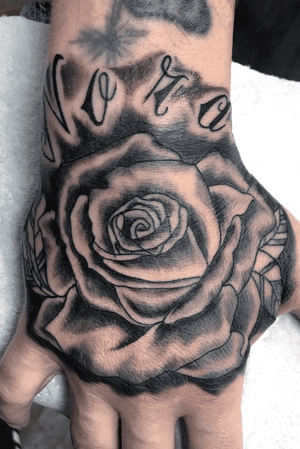 Black and grey rose on the hand.