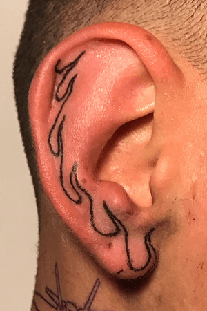 Handpoked flames on ear
