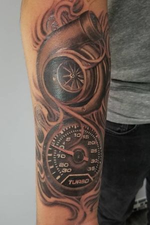 Get revved up with this stunning black and gray realistic tattoo of a car speedometer, expertly done by Josue Cortez. Perfect for arm placement.