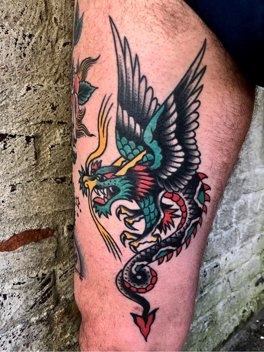 Tattoo of a dragon located on the forearm done in
