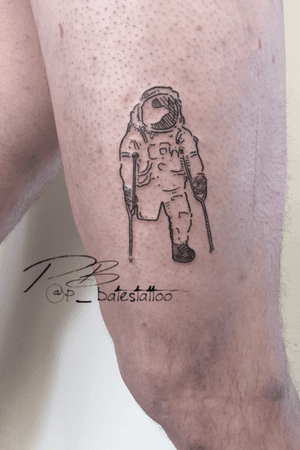 Explore the cosmos with this detailed blackwork astronaut and walking stick tattoo by artist Patrick Bates on your upper leg.