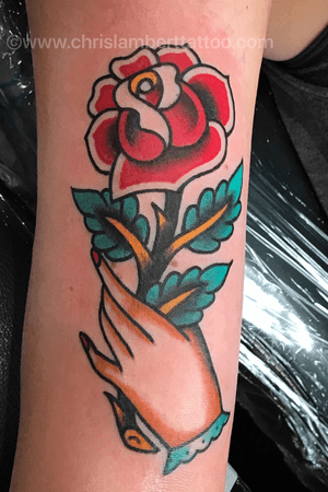 Traditional hand and rose tattoo on upper arm. Tattooed at Snake and Tiger Tattoo in Leeds city centre UK